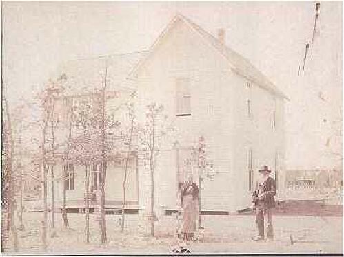 James and Emma Purvis in front of their home